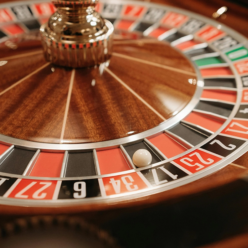 Close-up of a roulette wheel with a ball on the black number 17 pocket.